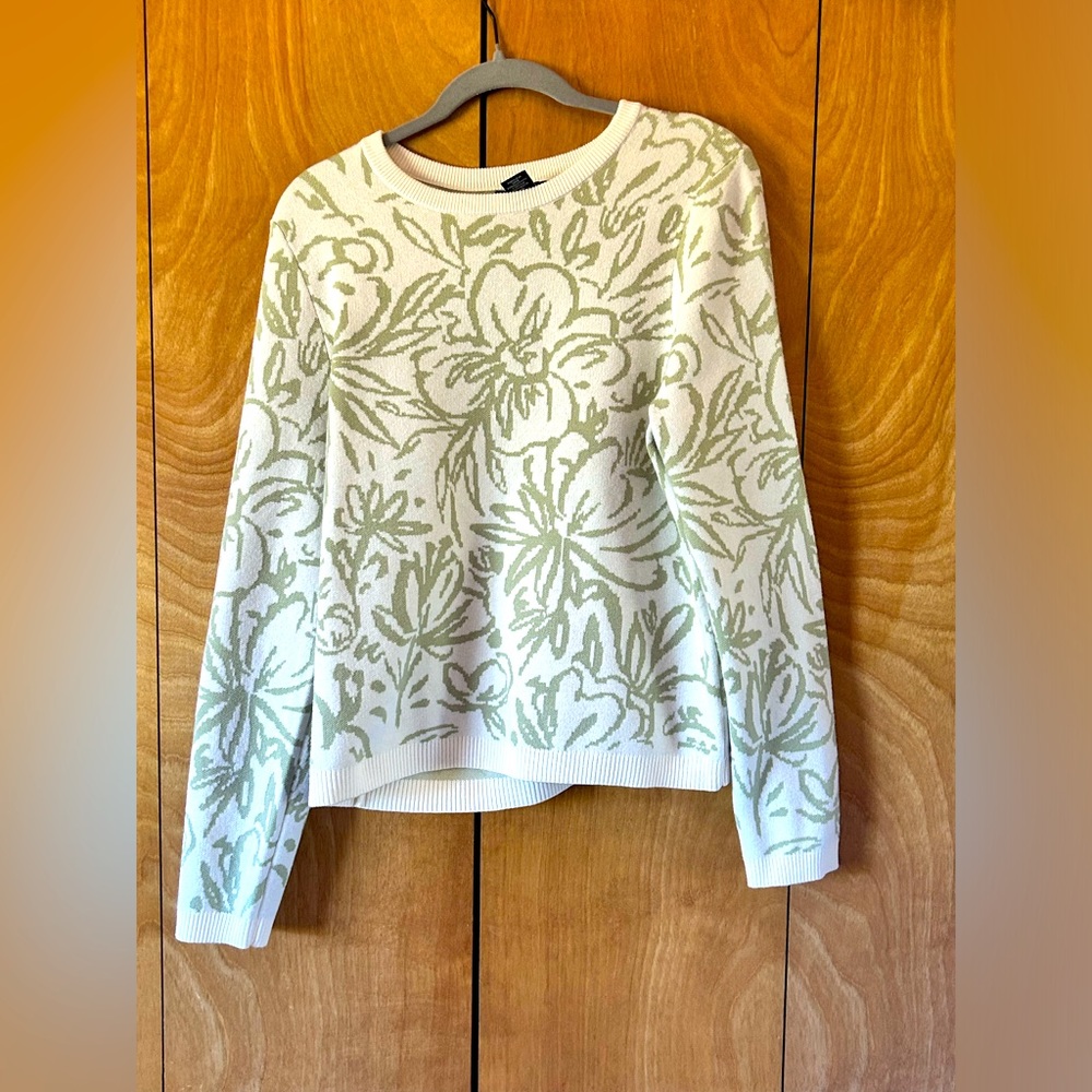 White with green flowered sweater.